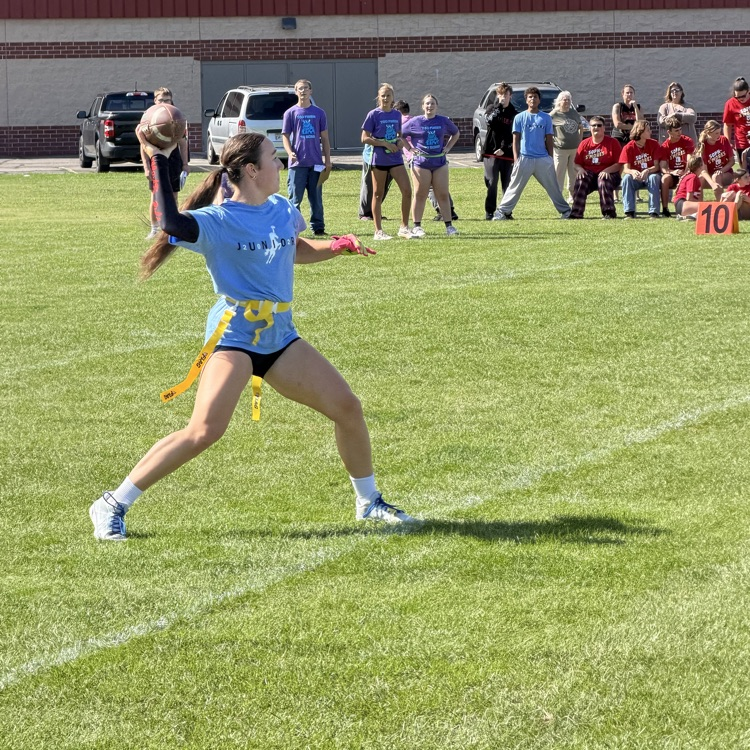 student throwing football