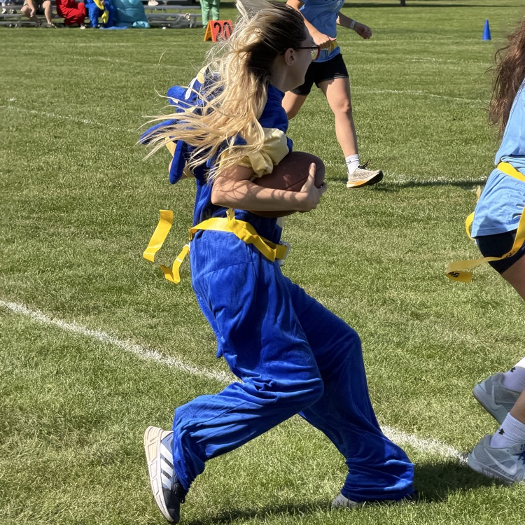 student running with football