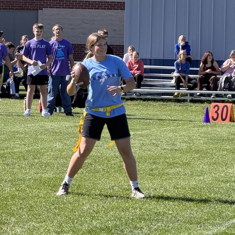 student throwing football