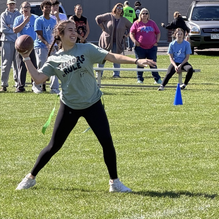 student throwing football