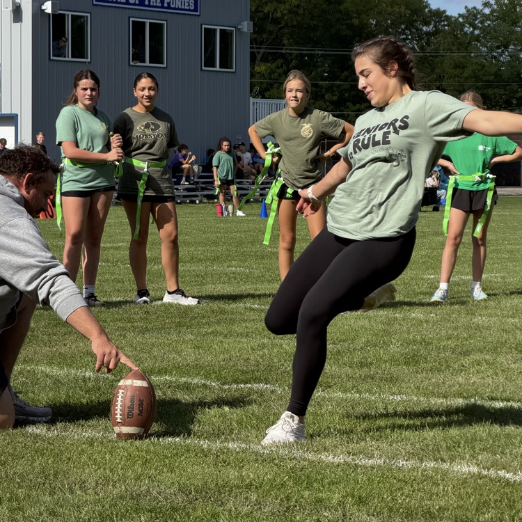 student kicking football