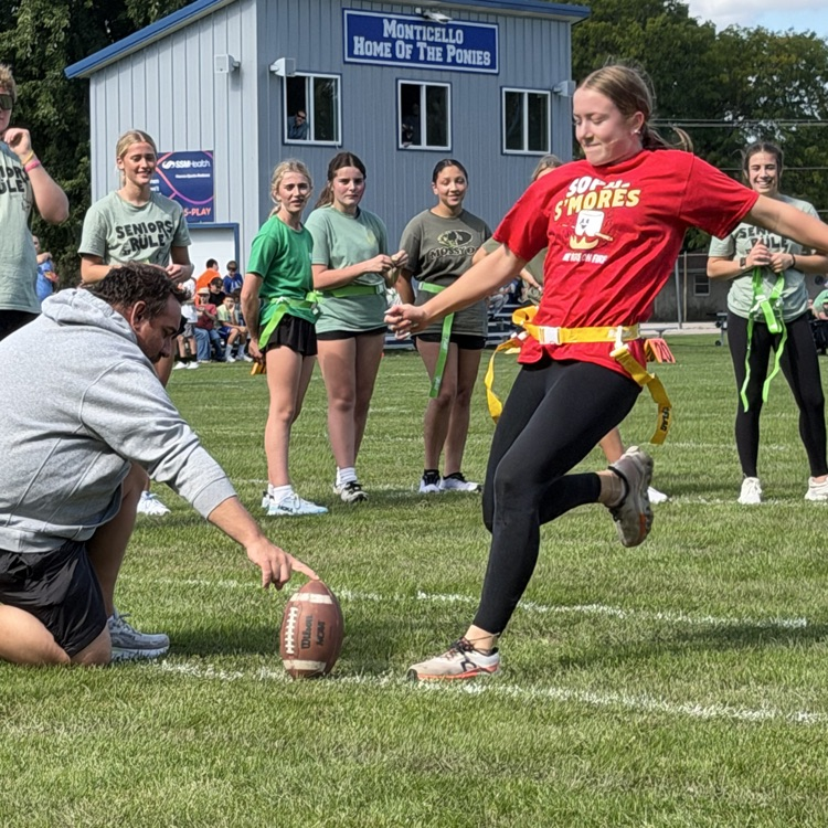 student kicking football