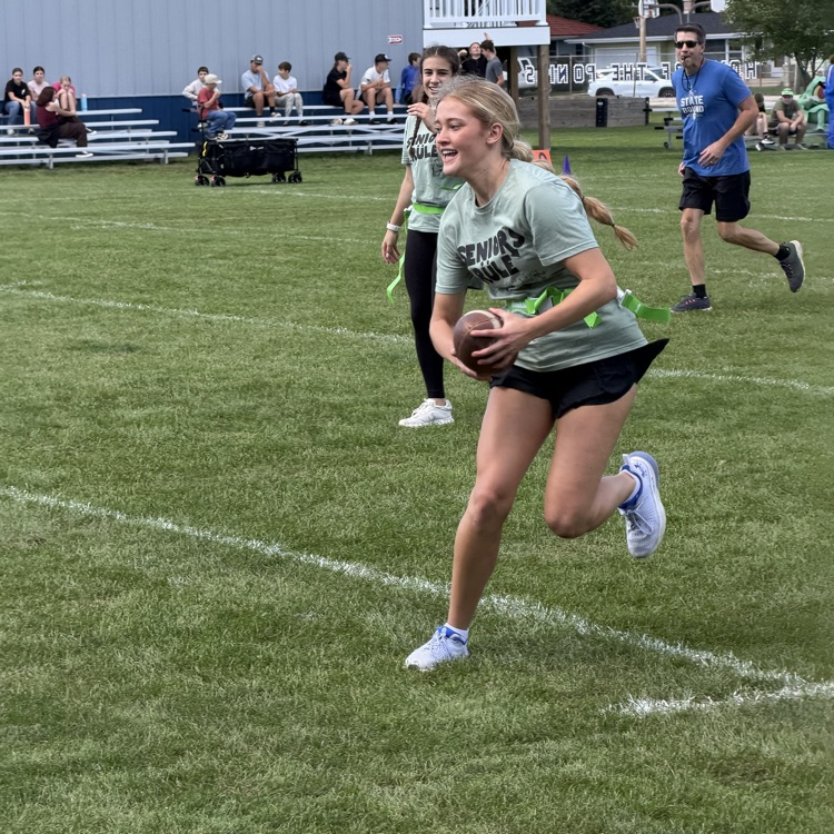 student running with football