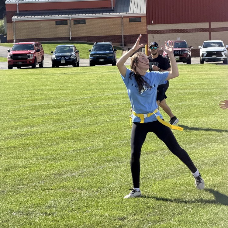 student catching football