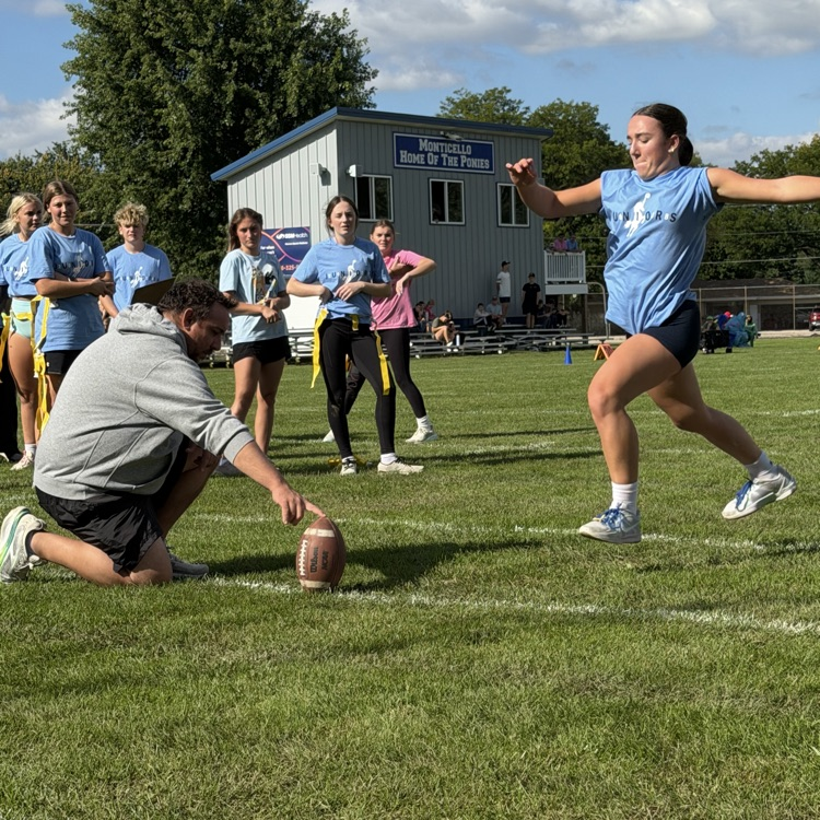 student kicking football