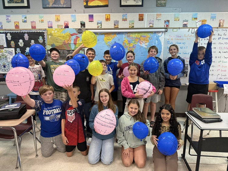 students holding balloon globes