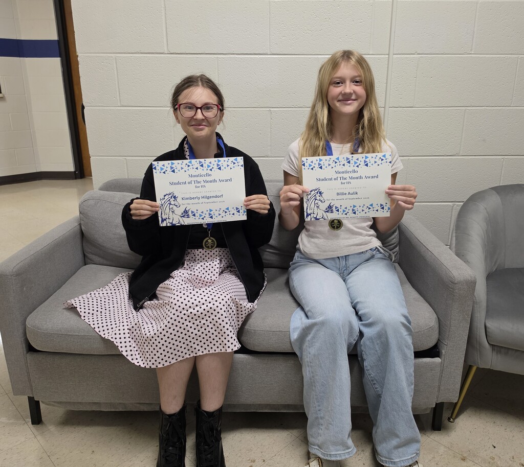 Smiling Students of the Month Holding Certificates