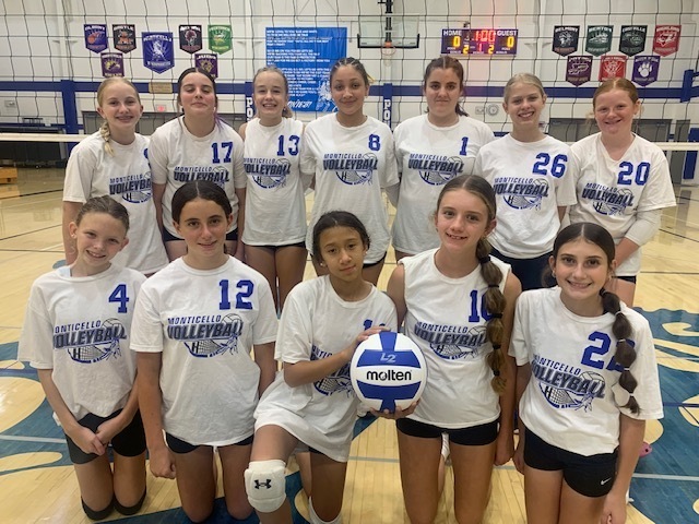 7th and 8th Grade Volleyball Players Smiling and Holding a Volleyball