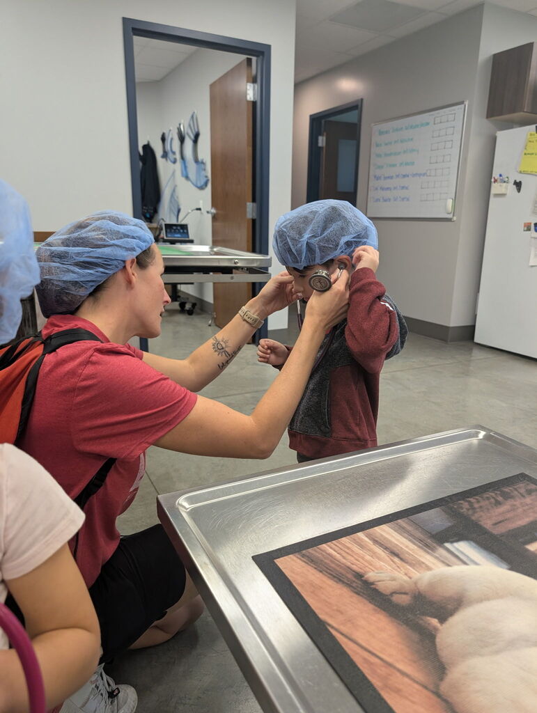 Elemenatry Teacher Helping Student with Hair Net