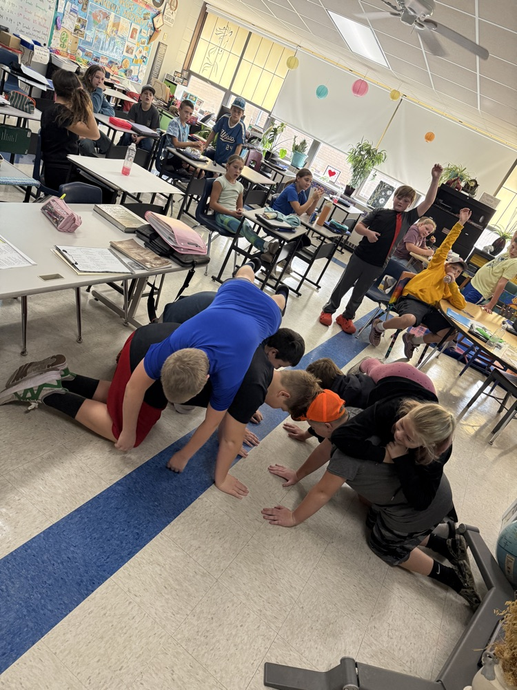 Middle school students creating a plateau in charades.