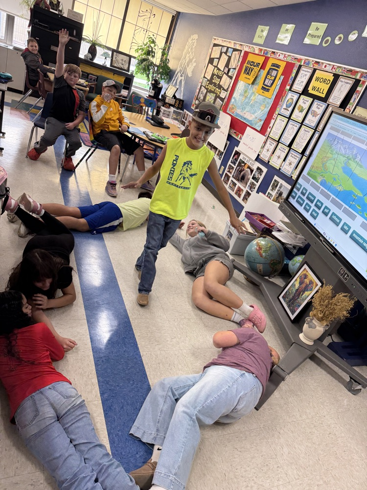 Middle school students creating a bay in charades.