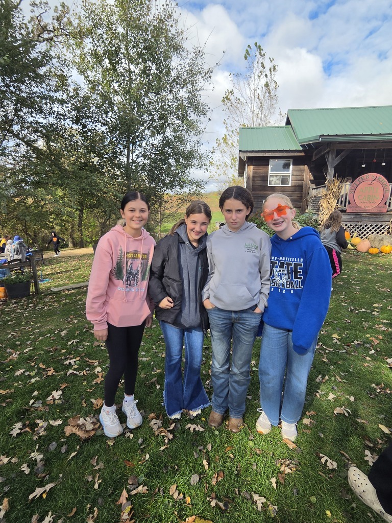 Girls standing in front of Sutter's Ridge store.