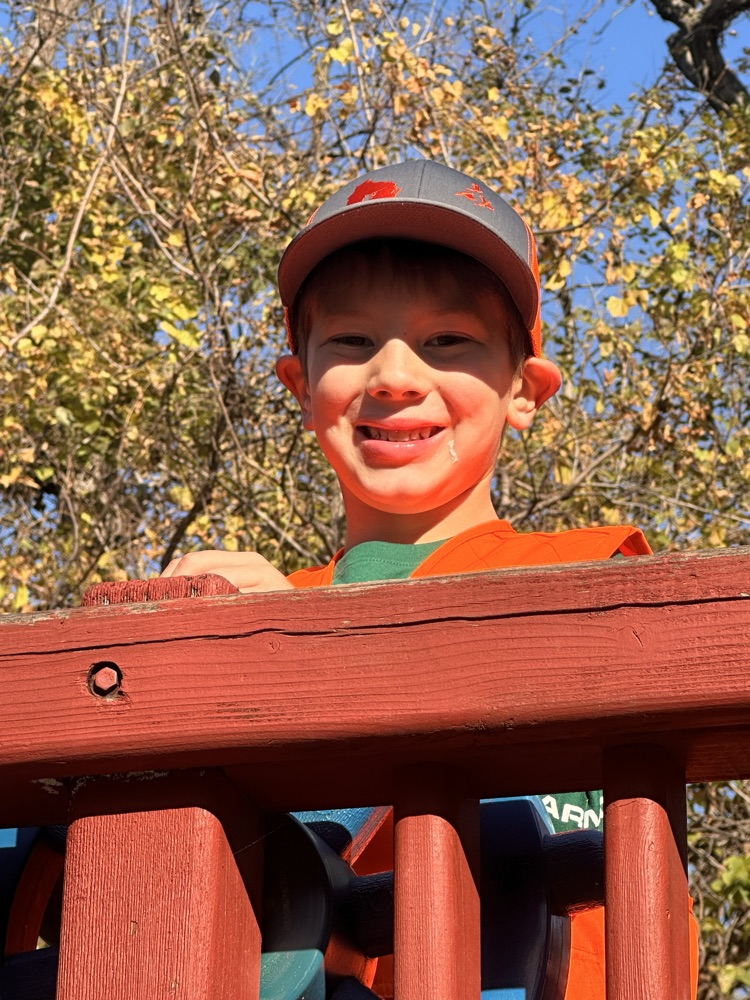 Student smiling on playground.