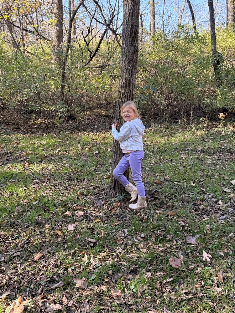 A child hugging a tree.