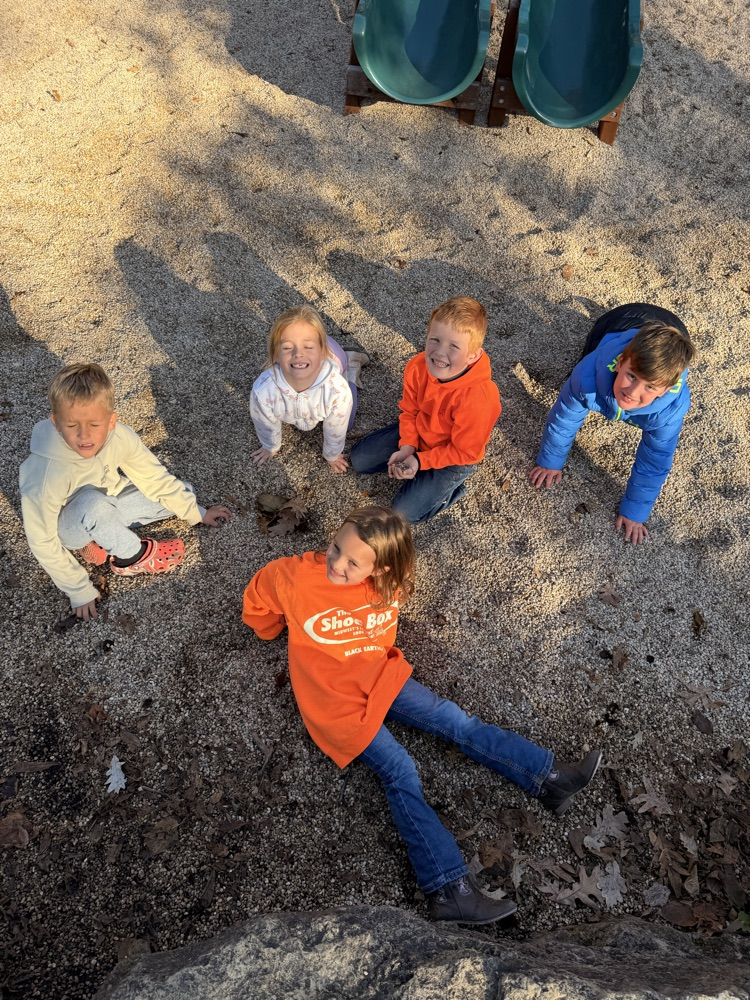 Five children playing in the rocks.