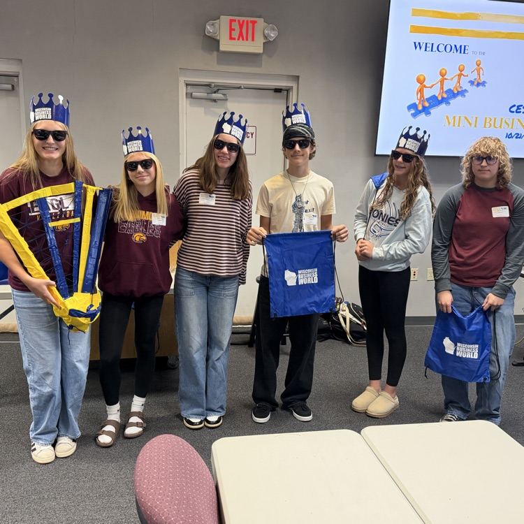 Six FBLA students standing with their winning project, the Mega Mitt, for catching baseballs.