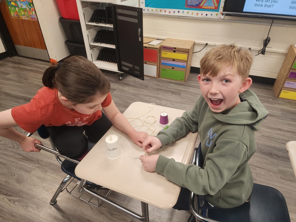 Students are making changes to their paper cup telephone to see if it will continue to work!