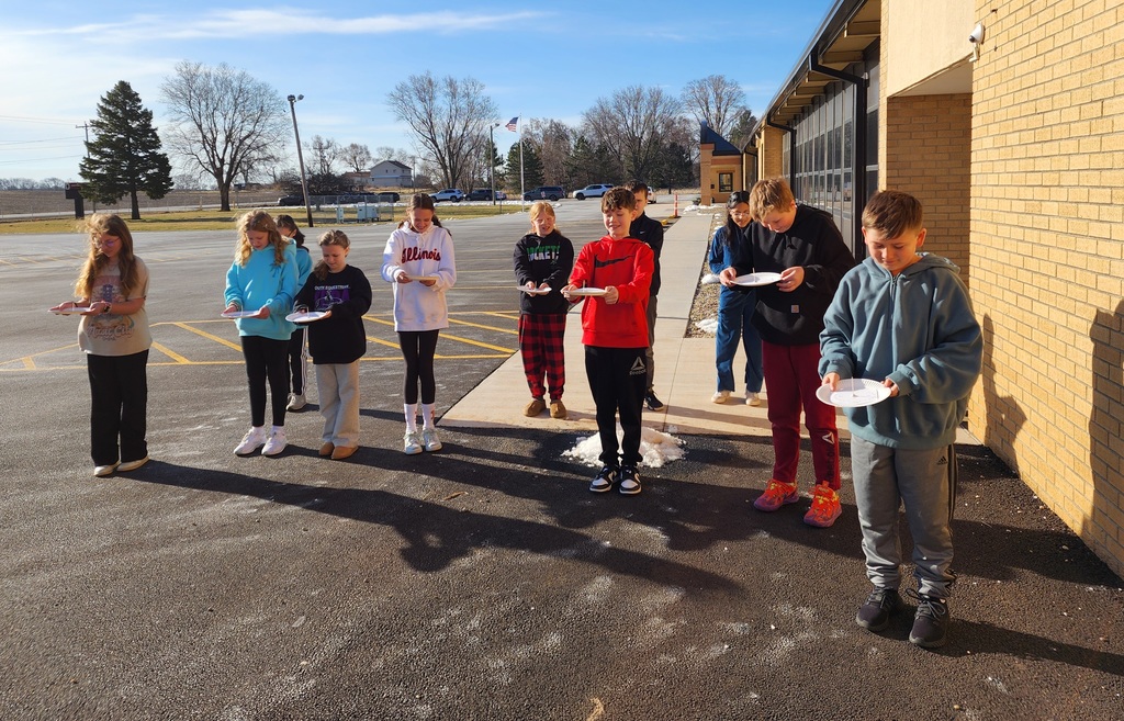 Students with their shadow clocks outside to see how the position of the sun tells them the time of day.