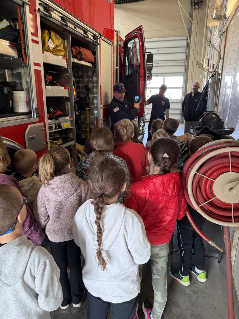 Mr. Kaffar sharing different parts of the fire station with the first and second graders.