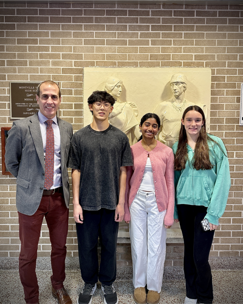 MTHS Principal stands with three students announced as National Merit Semifinalists