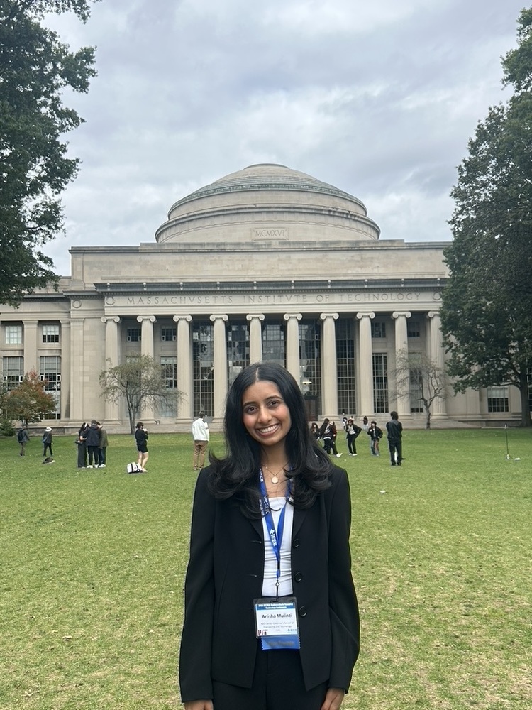 Student Anisha Mulinti stands at the "Great Dome" on the campus of MIT.