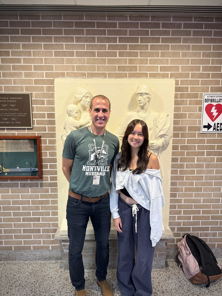 Principal Doug Sanford stands with National Speech and Debate Academic All American Award winner Amy Zhang