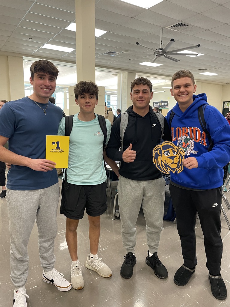 four students stand together in the college fair