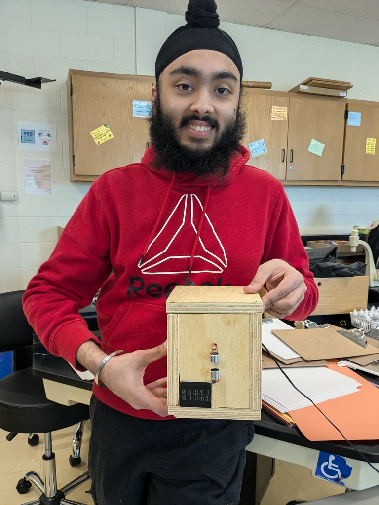 Students poses with his custom built acoustic levitation system