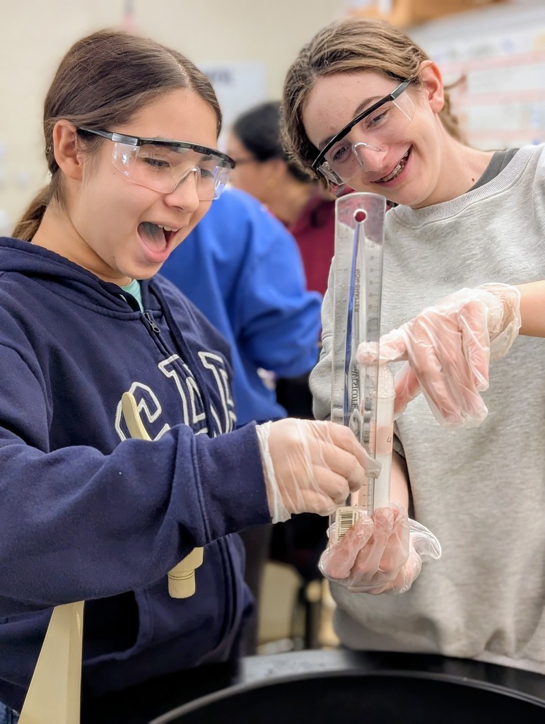Biology students performing the catalase lab.  Students are measuring the amount of oxygen gas produced from the decomposition of hydrogen peroxide in the presence of an enzyme.  