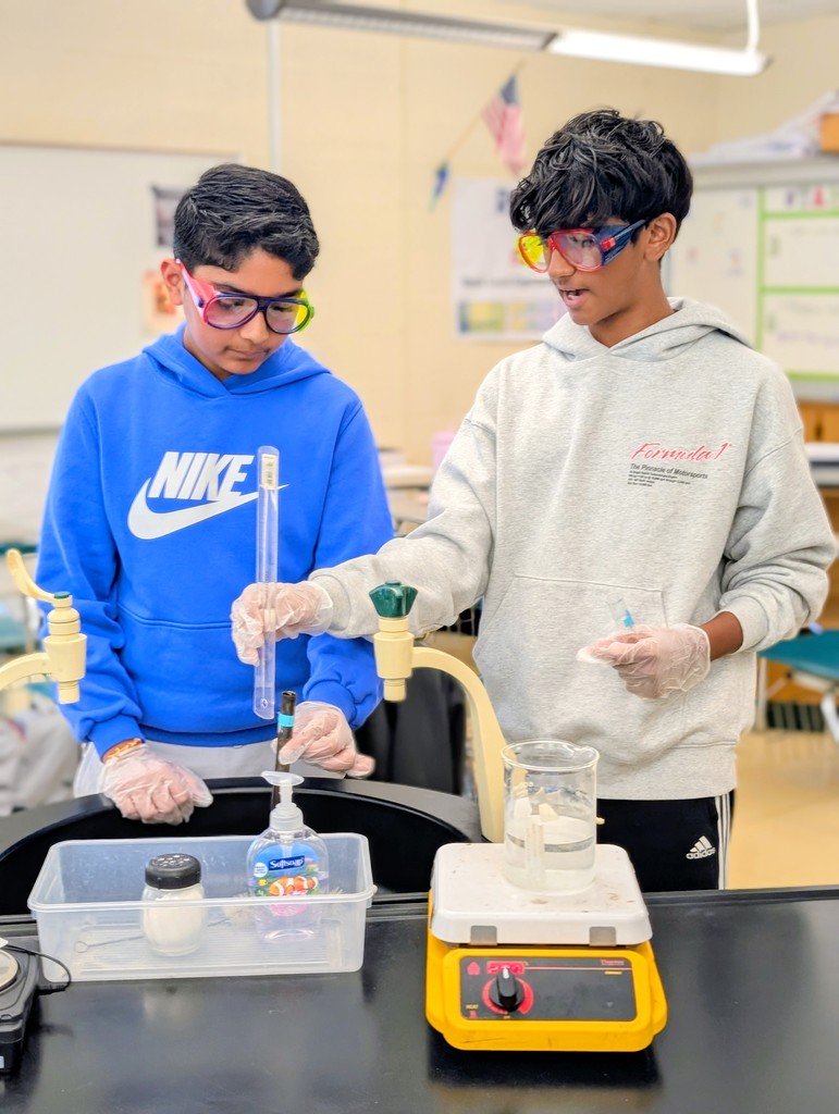 Biology students performing the catalase lab.  Students are measuring the amount of oxygen gas produced from the decomposition of hydrogen peroxide in the presence of an enzyme.  