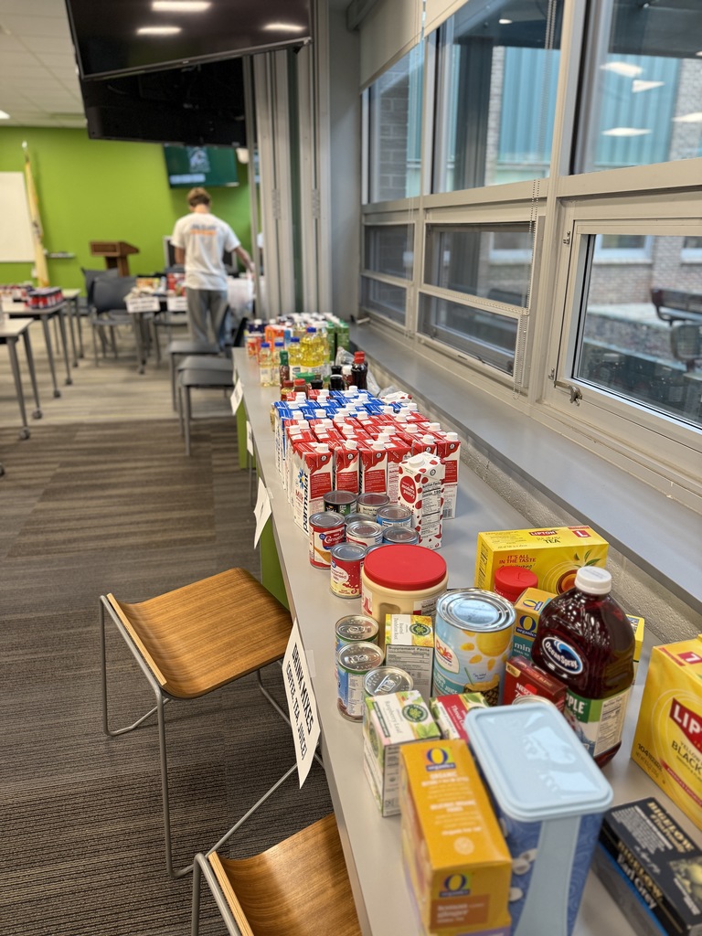 table lined with various items for the Key Club food drive. 