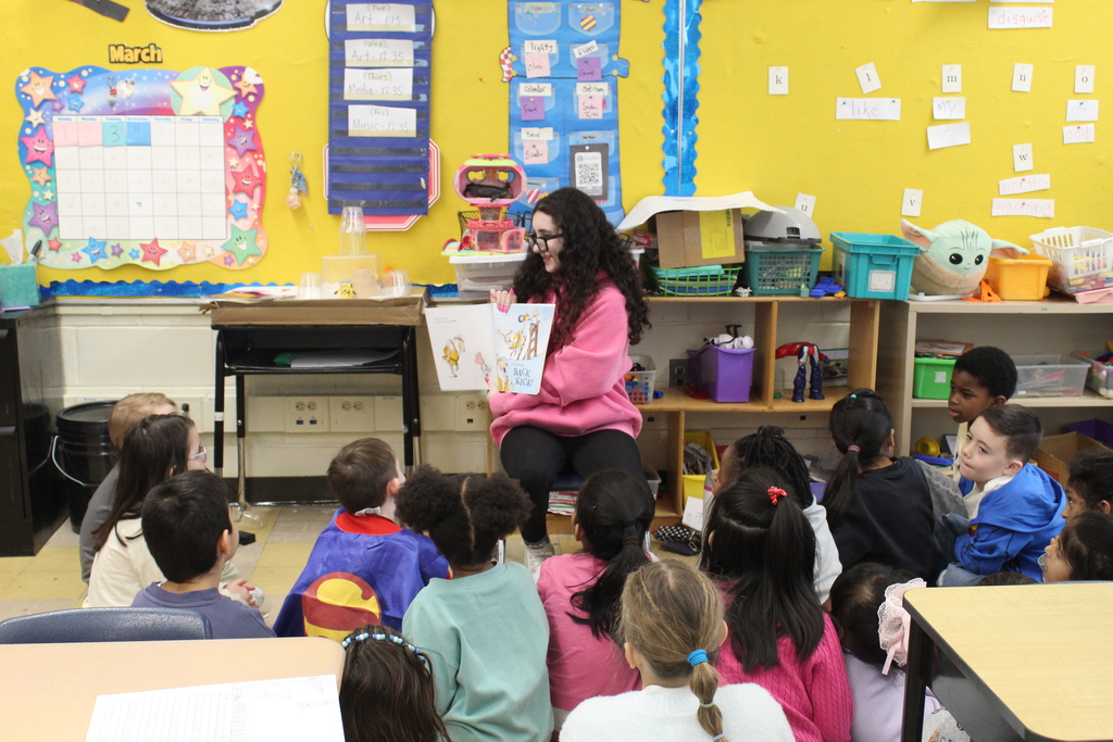 Twelfth grade students travel back to their elementary schools to celebrate Read Across America