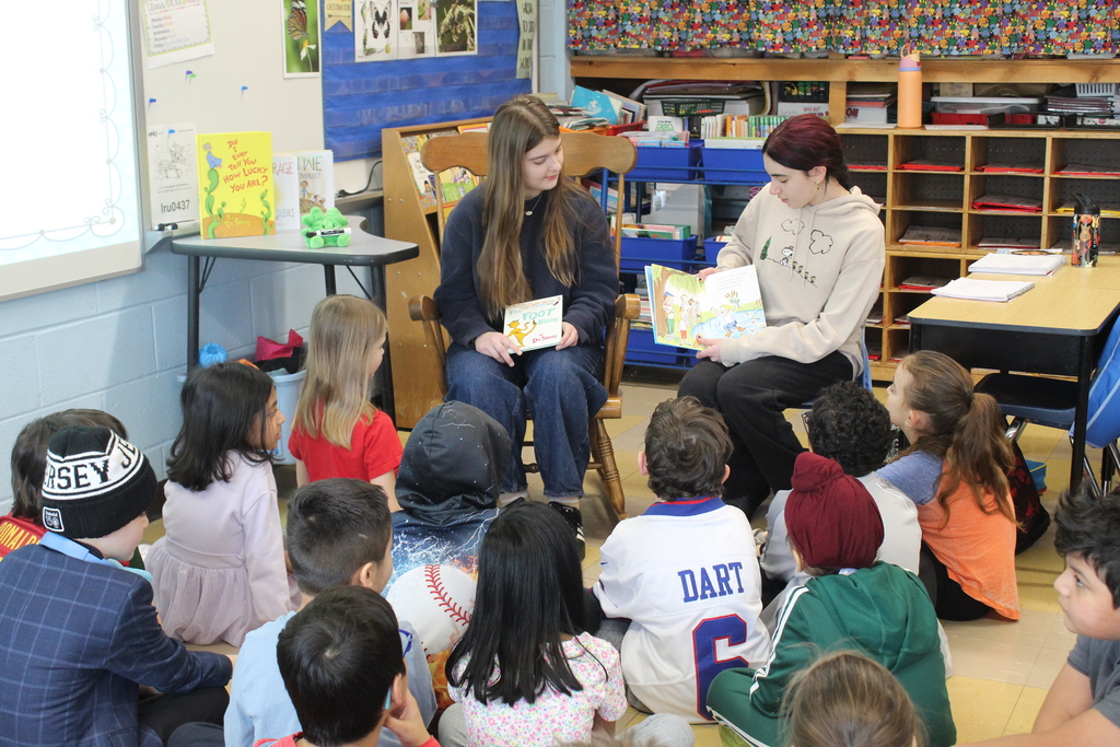 Twelfth grade students travel back to their elementary schools to celebrate Read Across America
