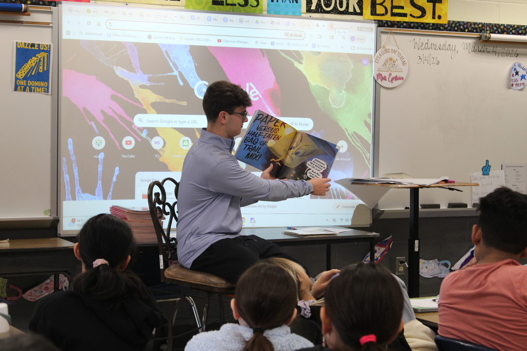 Twelfth grade students travel back to their elementary schools to celebrate Read Across America