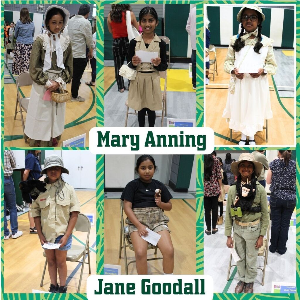 Children are dressed up as historical figures Mary Anning and Jane Goodall. They wear period costumes and hold props, smiling in a school gym.
