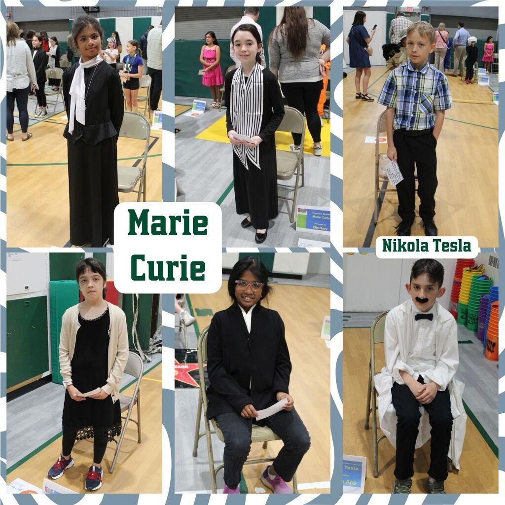 Children dressed as historical figures Marie Curie and Nikola Tesla stand or sit in a school event. They wear period-appropriate outfits, looking serious.