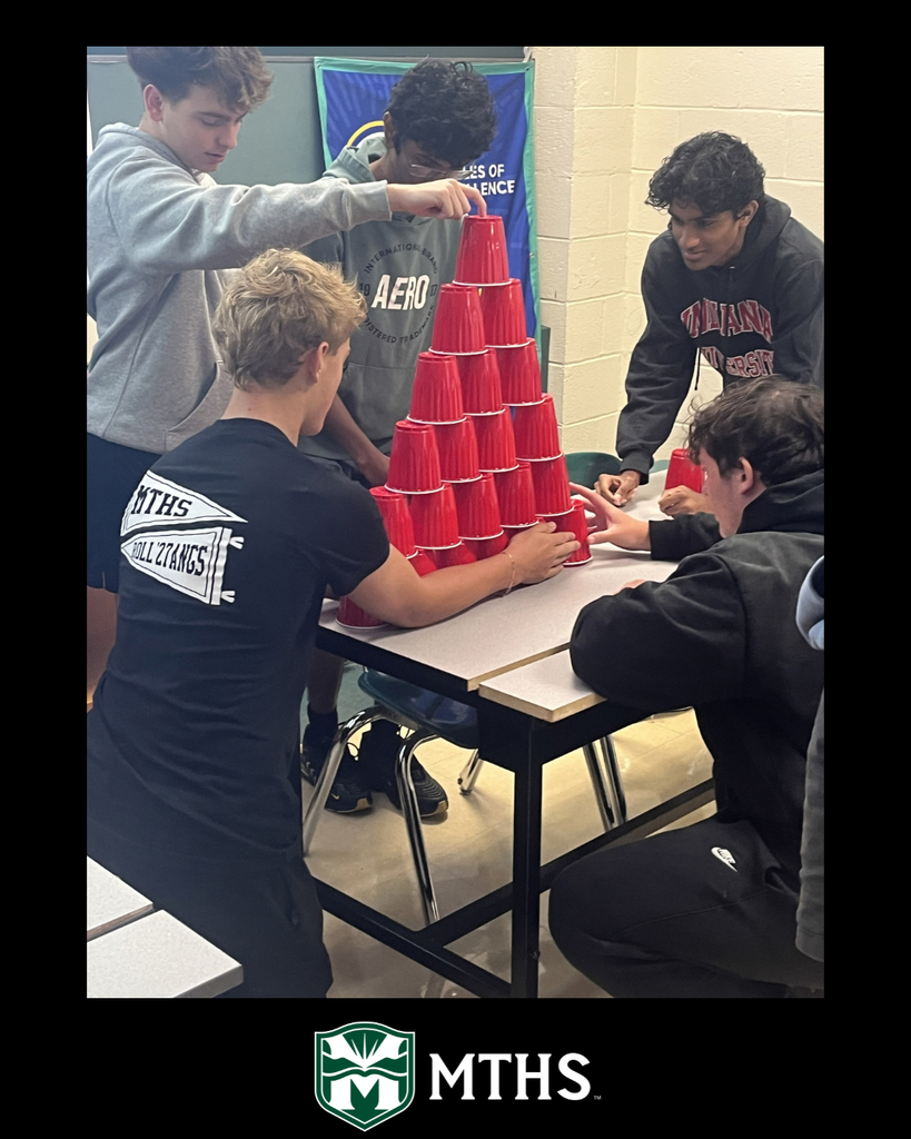 Students in Mr. Connolly's class use Solo cups to compete in the Reverse Pyramid activity to build teamwork.