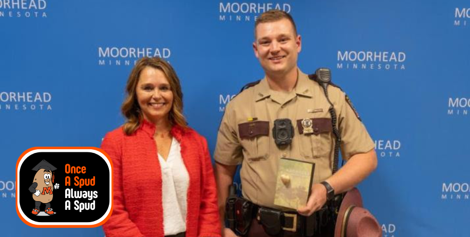Mayor Shelly Carlson presents Zach Gruver with the MoorHeart Award