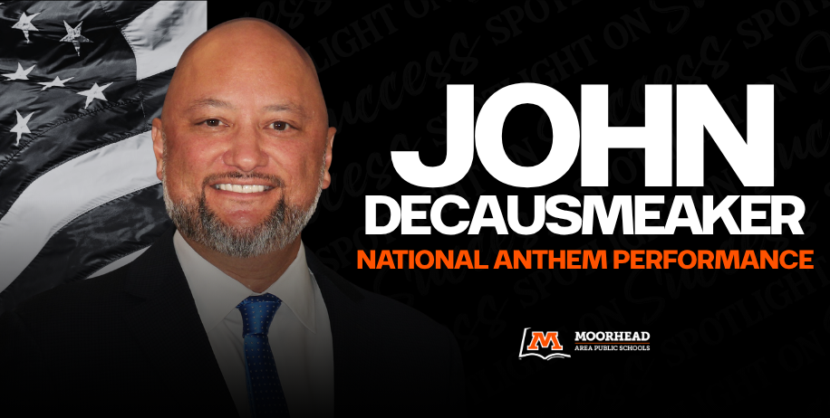John deCausmeaker infront of an American flag saying National Anthem Performance