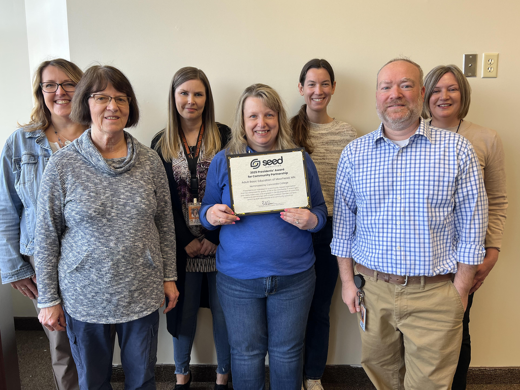 Adult Basic Education Staff holding seed award