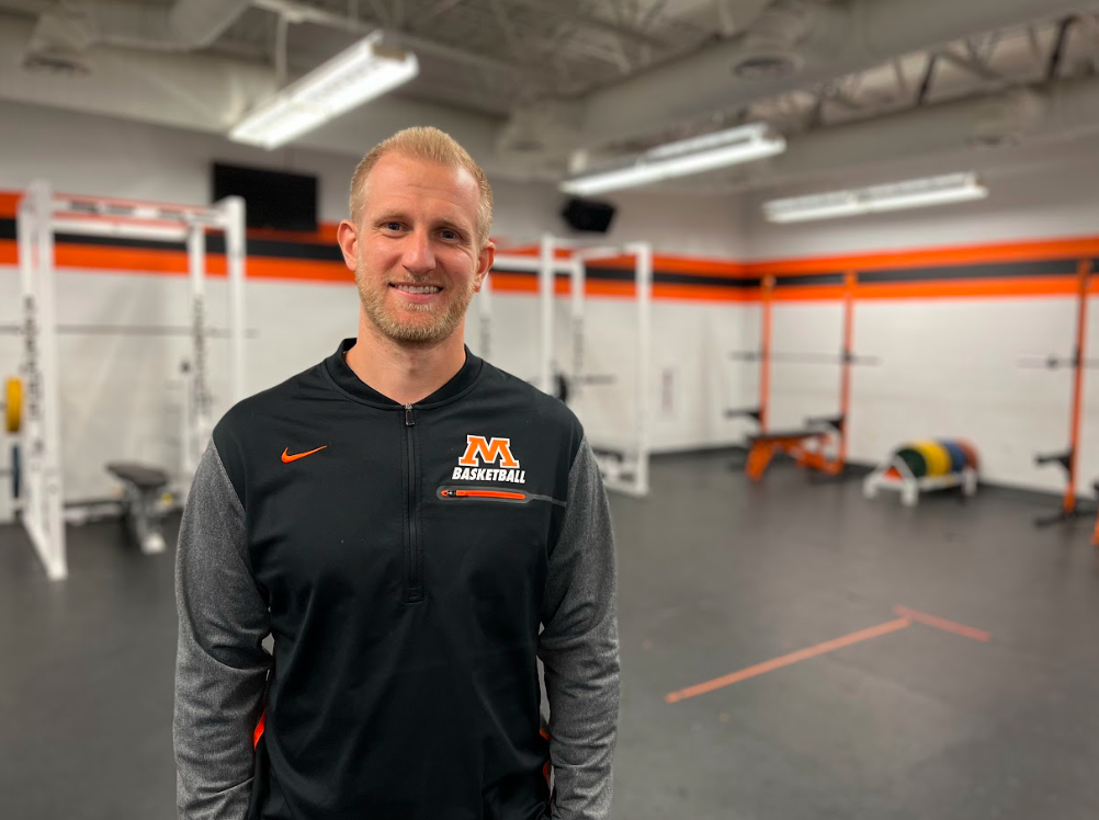 Cory Holten poses for photo for story about being awarded Certified Master Athletic Administrator credential