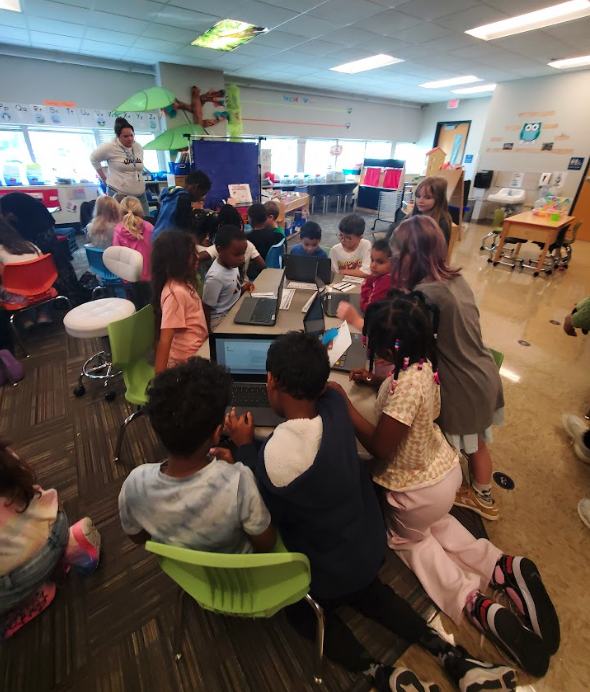 Third Grade helping Kindergarteners log into chromebook