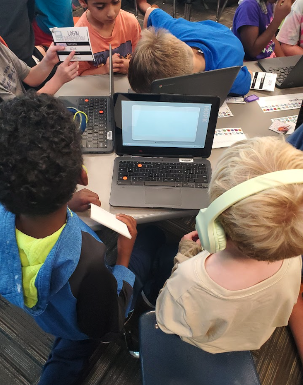 Third Grade helping Kindergarteners log into chromebook