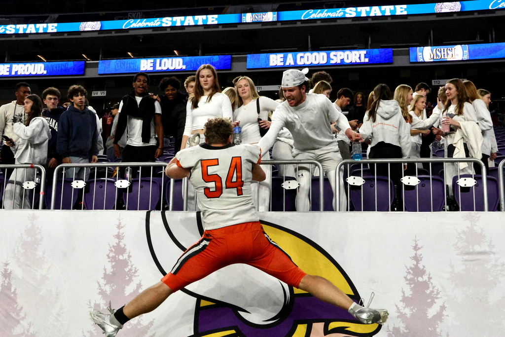 Logan Olson Jumping up to high five friend Bridger Hansen