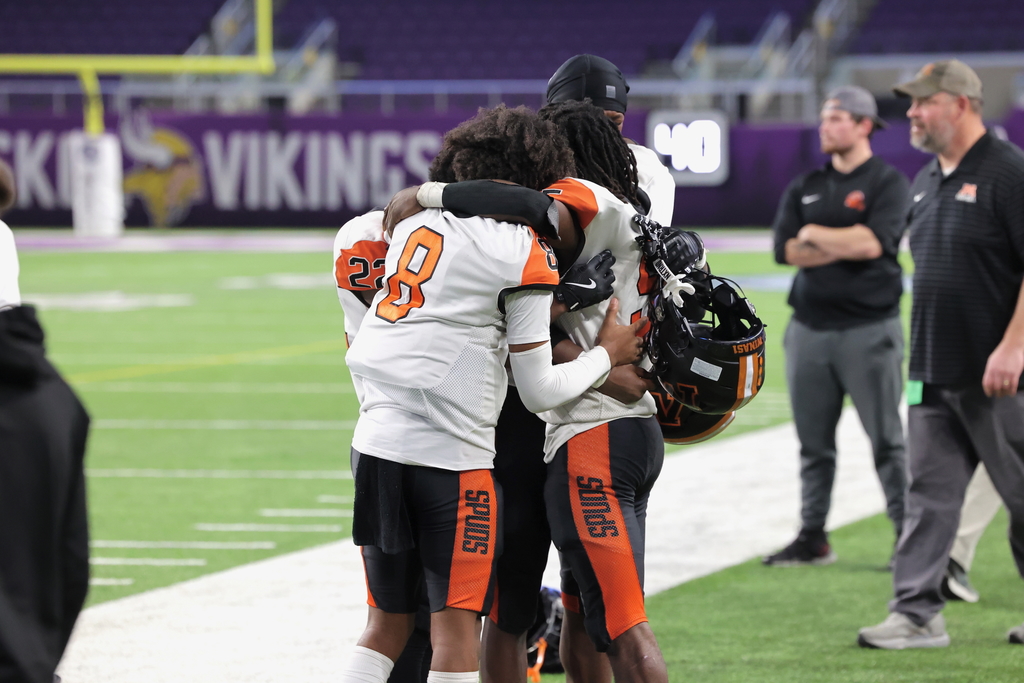 four players embrace in a hug