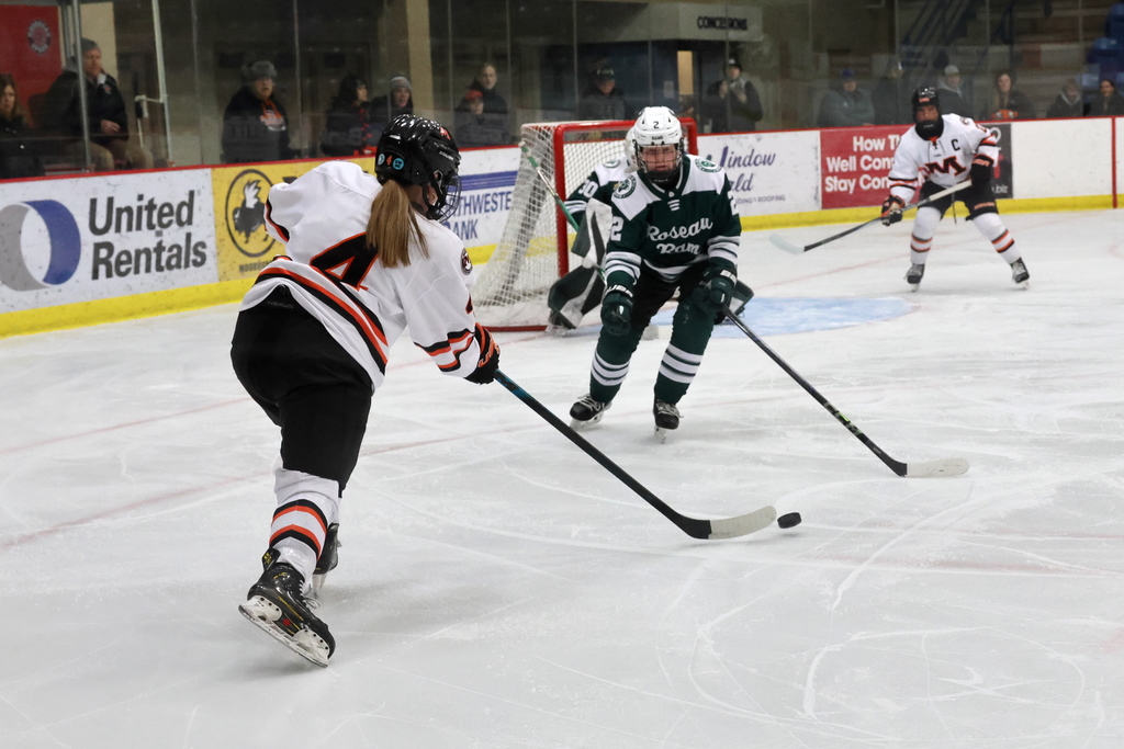 Anna Bjorkman Passes the puck to Shay Benson