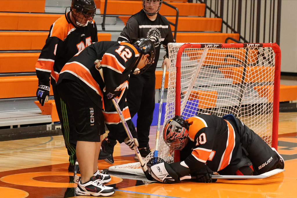 Two Moorhead players and their goalie stop the puck against Buffalo/Monticello/STMA