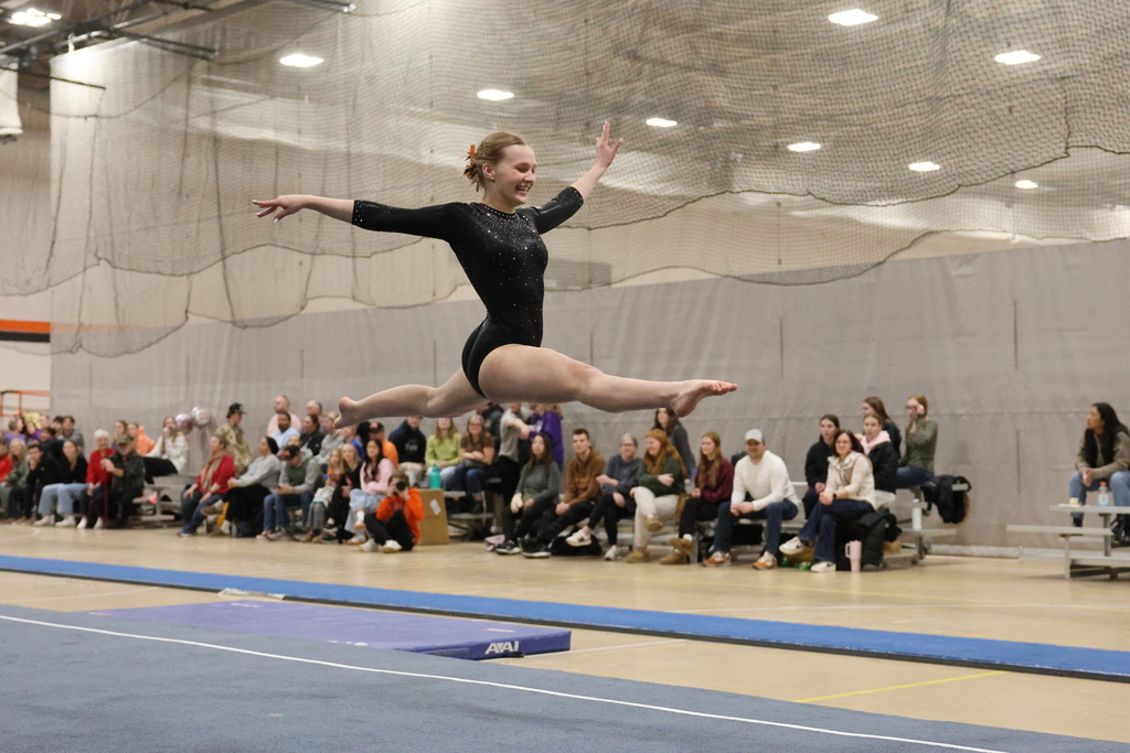 Womens gymnastics leap in floor routine