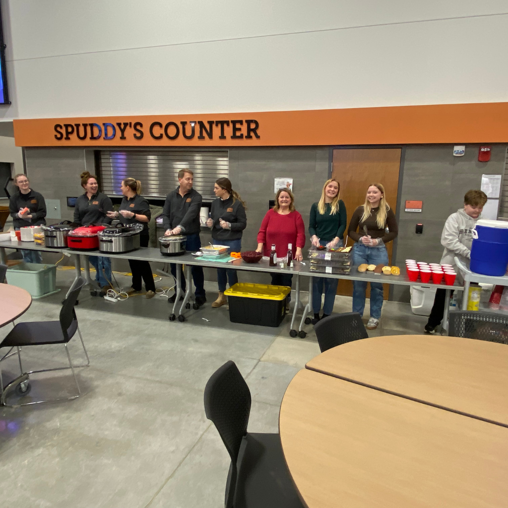 Volunteers serving dinner at a Spud Locker donation event