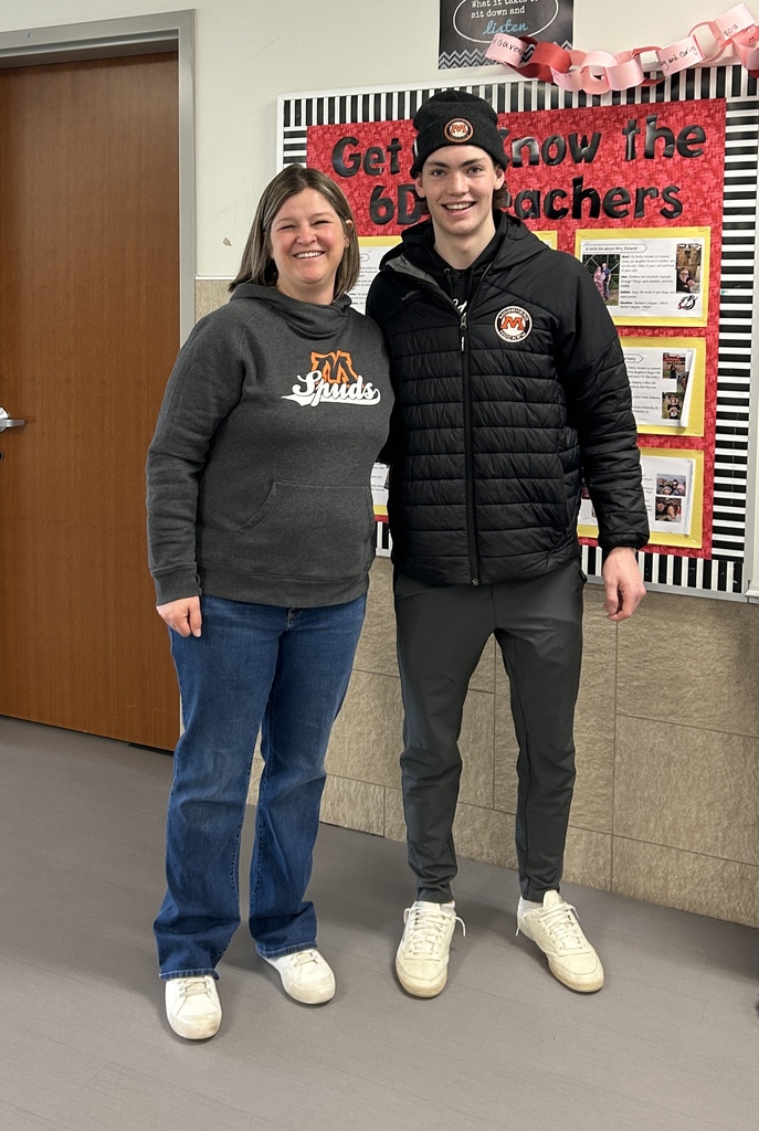 Max Cullen taking a photo with his middle school teacher